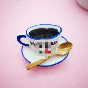 Miniature white resin coffee cup and saucer set with blue trim and golden spoon
