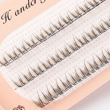 Close-up of handcrafted black half-lash clusters on a pink polka dot card