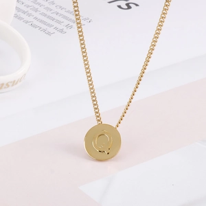 Minimalist gold stainless steel necklace featuring a round pendant with cutout letter Q