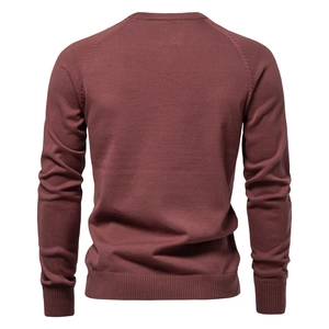 Detail view of burgundy cotton knitted sweater featuring raglan sleeves and ribbed cuffs