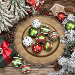 Polished red and green Christmas ornaments with glitter patterns on a wooden surface