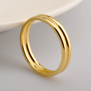 Macro detail of 18k gold plated stainless steel double band ring with polished finish