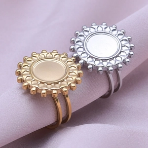 Detail of adjustable sunflower ring bases in gold and silver on silk background