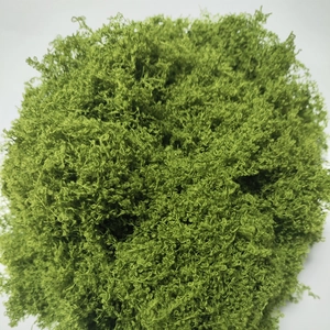 Detailed close-up of artificial green moss with a soft fiber texture for micro landscapes