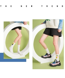Detail of white cotton crew socks with smiley face embroidery and sporty casual sandals