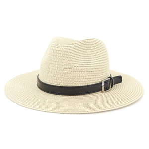 Detail of off-white straw sun hat with black leather band and silver metal buckle