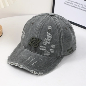 Vintage dark gray washed denim baseball cap with green OK embroidery and distressed holes