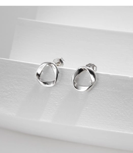 Macro shot of silver minimalist twisted hoop earrings with s925 hallmark and butterfly back