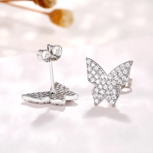 Detailed macro shot of silver butterfly stud earrings with micro-pave cubic zirconia