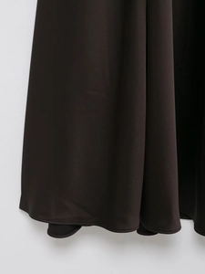 Close-up of smooth satin fabric hem and stitching on a slim elegant formal long dress