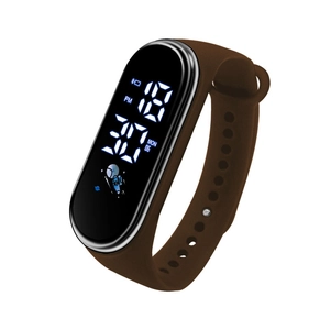 Macro side view of brown silicone band and digital LED screen with astronaut graphic