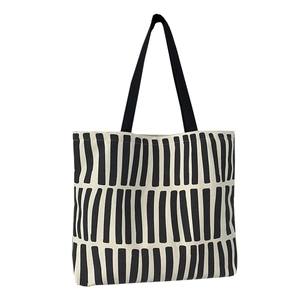 Minimalist canvas tote bag with black and white geometric stripes and black shoulder straps