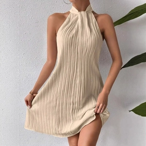 Elegant beige halter neck pleated mini dress with a draped silhouette and sleeveless design