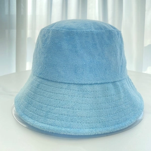 Detailed texture of light blue terry cloth fabric on a minimalist bucket hat