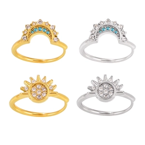Set of minimalist sun and moon zircon rings in gold and silver finish on white background