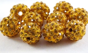 Macro view of a 10mm yellow Shamballa bead with faceted crystals for DIY jewelry