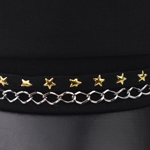 Detail shot of a black military beret hat with gold stars and silver chain accessories