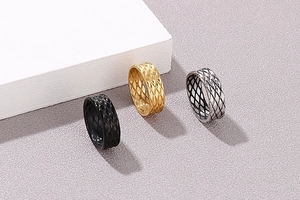 Detailed macro view of titanium steel rings with textured diamond mesh engraving pattern
