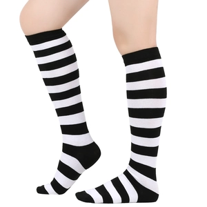 Detail of knee-high socks featuring black and white horizontal stripes and elastic cuffs