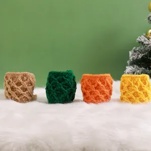 Macro view of handmade chunky knit mug sleeves in four festive colors on plush white rug