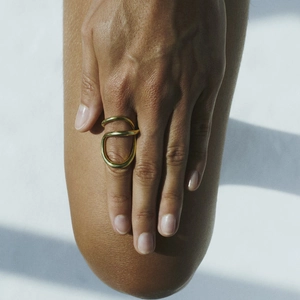Modern gold irregular twisted wire ring in stainless steel with minimalist aesthetic