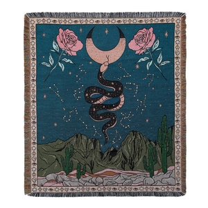 Bohemian woven picnic blanket with crescent moon, snake, and floral desert patterns