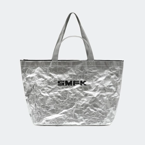 Macro shot of silver metallic gym bag texture with black logo and top zipper