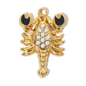 Close-up of golden lobster pendant with white rhinestones and black enamel details