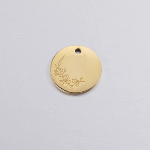 Detailed view of a golden 2cm round birthday flower pendant featuring cherry blossom design