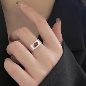 Detail of a 925 sterling silver wide band ring with a vintage oval red agate gemstone