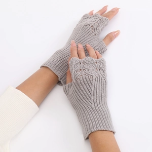 Close-up of light gray knitted fingerless gloves showing texture and fish scale weave