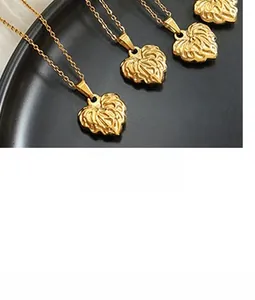 Macro shot of four golden heart-shaped pendants with delicate leaf vein textures