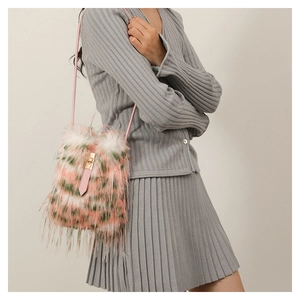 Detail showing the colorful faux fur texture and pink drawstring strap of the crossbody bag