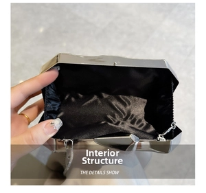 Detail view of acrylic clutch internal structure with silver frame and black satin lining