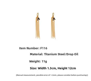 Detail of gold tassel earrings with black oil drop letter K and beaded chain fringe