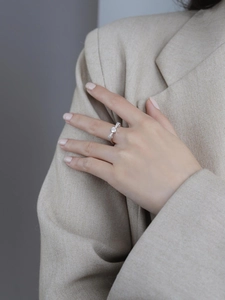Detailed close-up of S925 silver bow-knot moissanite ring with micro-pave diamonds