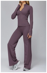 Detail view of purple yoga jacket with zipper, thumb holes and high waist wide leg pants