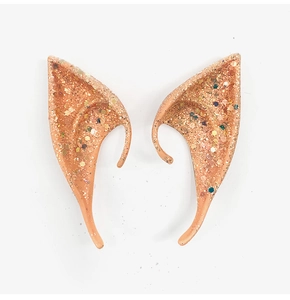 Close-up of sparkling latex elf ears with orange-pink base and multicolored glitter flakes