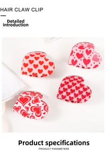 Close-up of four acrylic heart-shaped hair claw clips with pink and red patterns