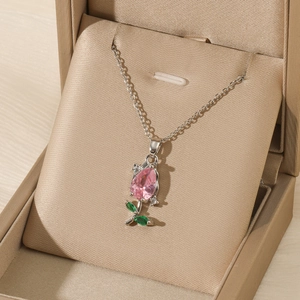 Detail shot of tulip necklace with pink zircon pendant on elegant jewelry gift box