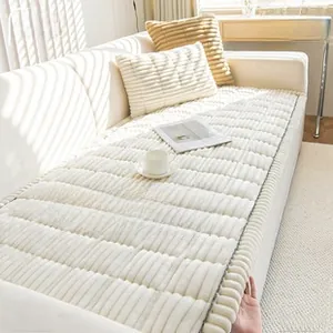 Close-up of thick cream-colored corduroy sofa cushion showing soft plush texture and stripes