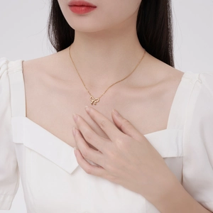 Elegant gold bow pendant necklace for women in a minimalist polished stainless steel style