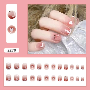 Short peach diamond press-on nails with pink gradient and white heart 3D nail art