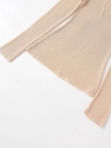 Macro detail of the fine plain weave texture on light beige knit long sleeve top