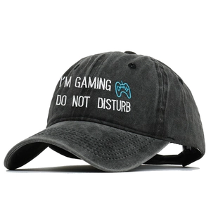 Detail of gaming embroidery and vintage washed cotton texture on black baseball cap