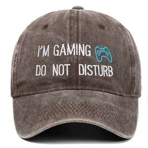 Close-up of gaming embroidery and washed brown cotton texture on the baseball cap