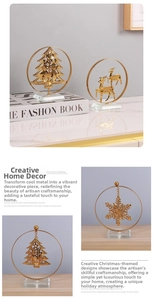 Detail of luxury gold metal Christmas tree and reindeer statues on crystal base
