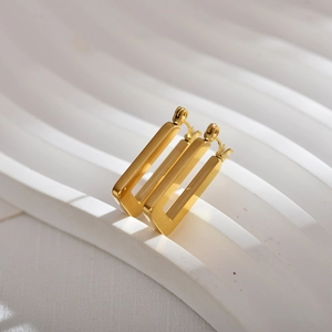 Macro view of geometric 18K gold plated stainless steel square earrings on white display