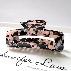 Detail of 8.3cm rectangular hair claw clip with pink and black tortoiseshell acetate texture