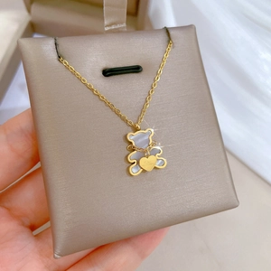 Minimalist titanium steel gold bear necklace with white mother-of-pearl heart detail